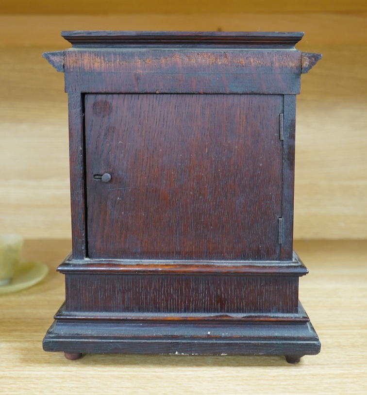 A late Victorian oak eight day mantel clock, striking on a coiled gong, height 26.5cm. Condition - fair, wear and oxidisation to dial.